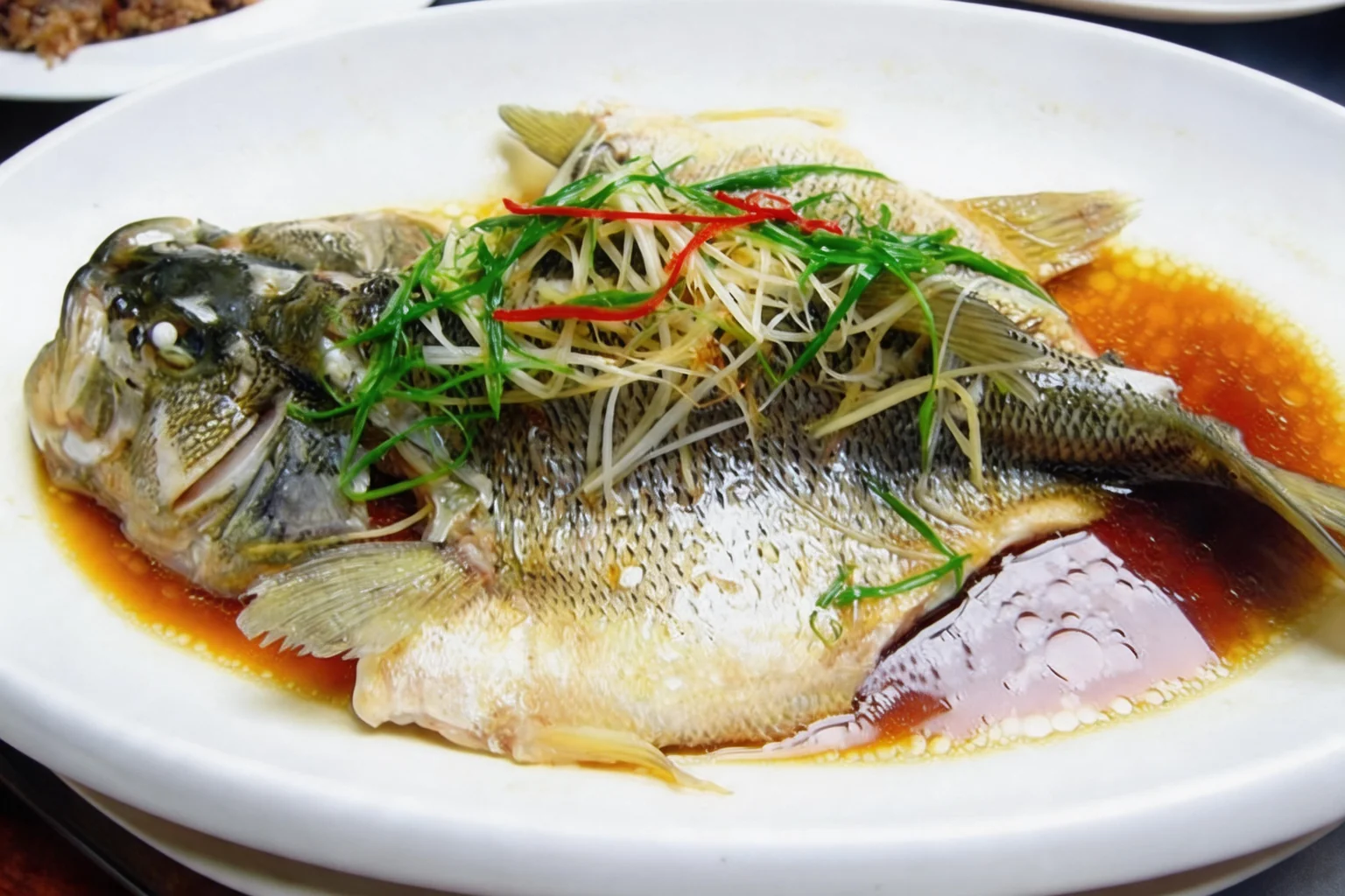 A01 Whole steamed sea bass, large white plate