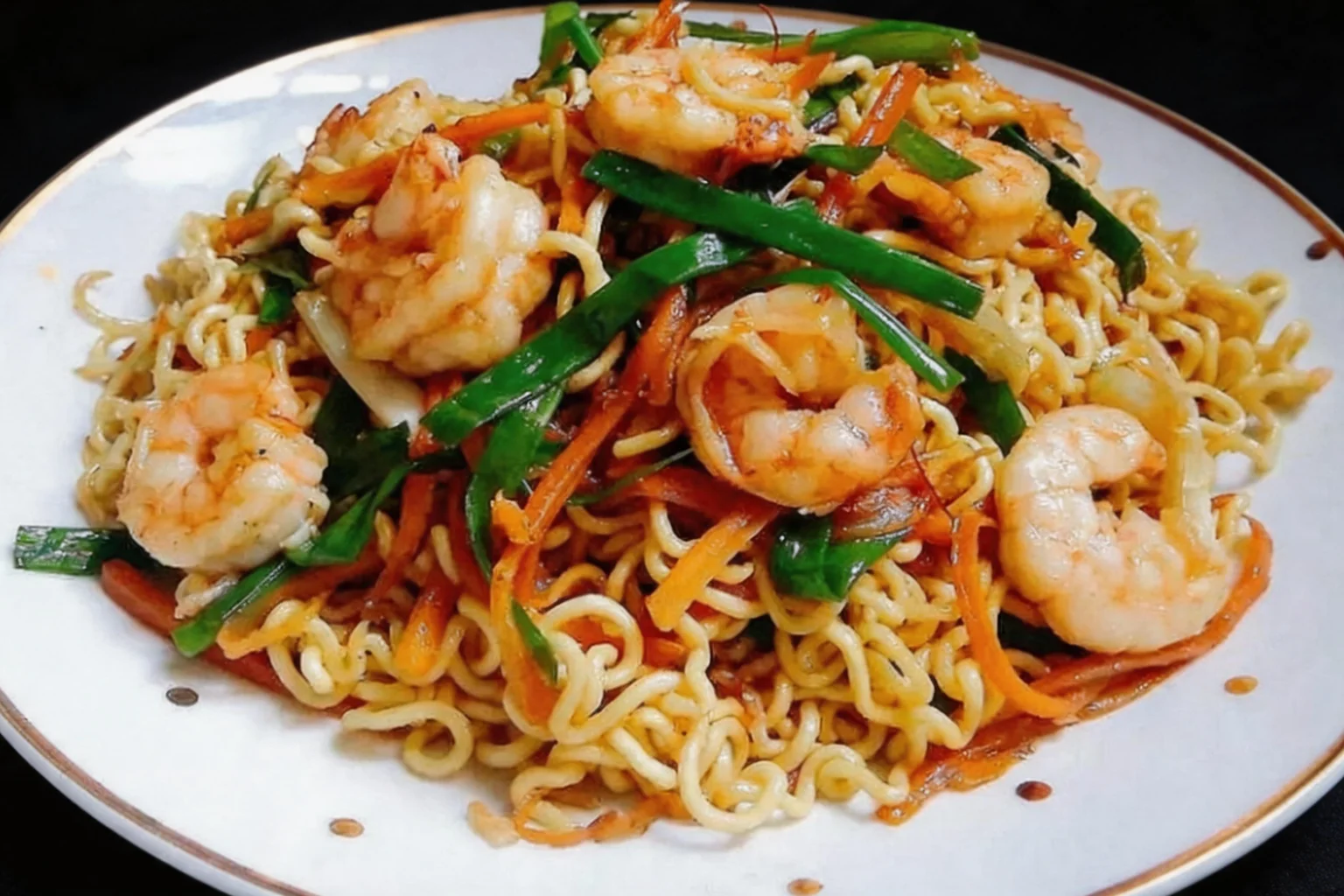 A33 Noodles sautéed with prawns, white plate with gold rim, dark background